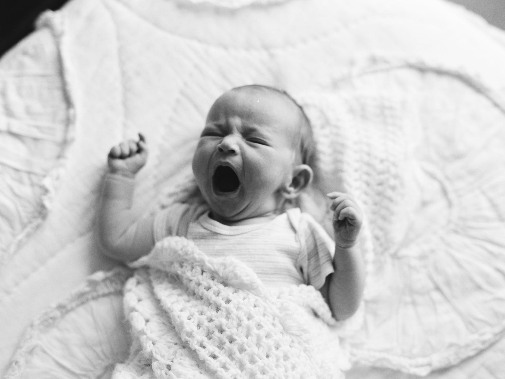 baby yawning black and white photo