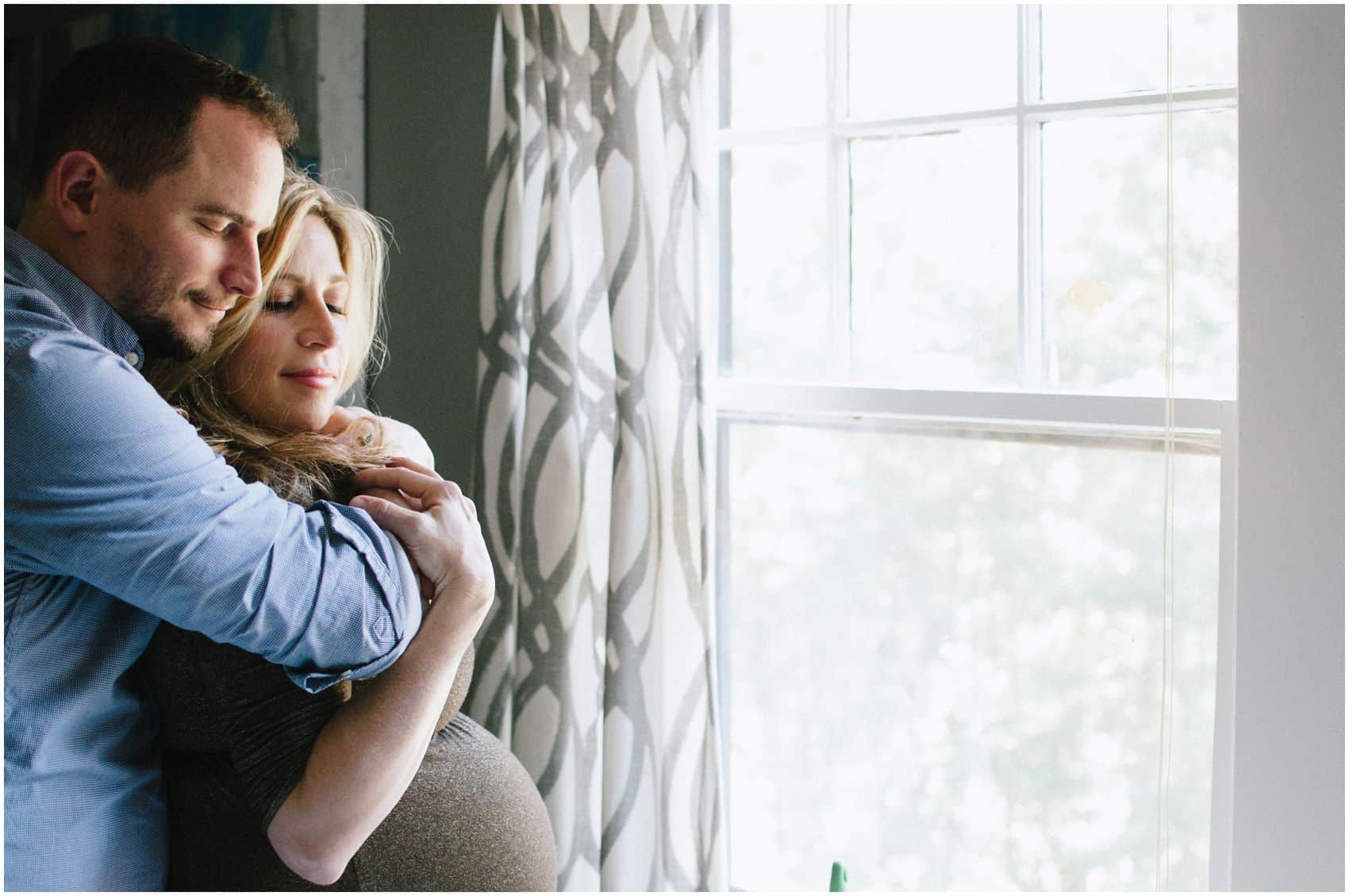 NYC couple snuggling for maternity photos