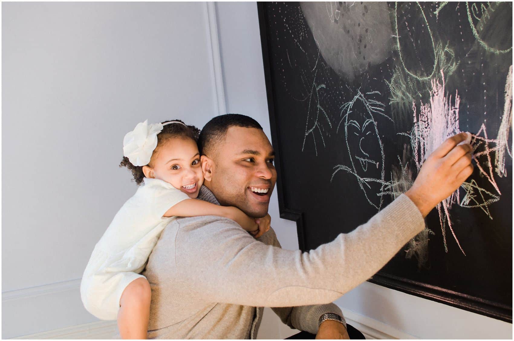 at home piggy back ride with daddy and drawing on the chalkboard in Manhattan NY