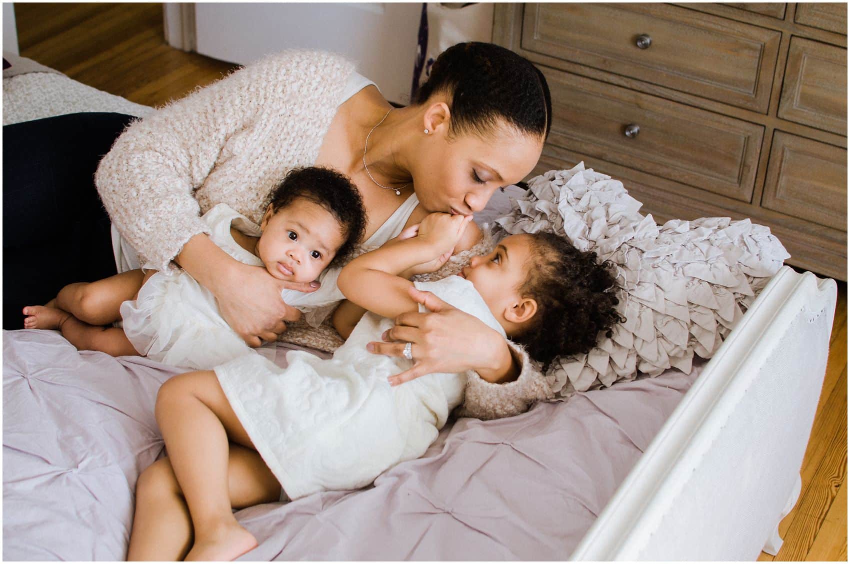 Mother cuddling with her two girls at her photo session in Manhattan NY
