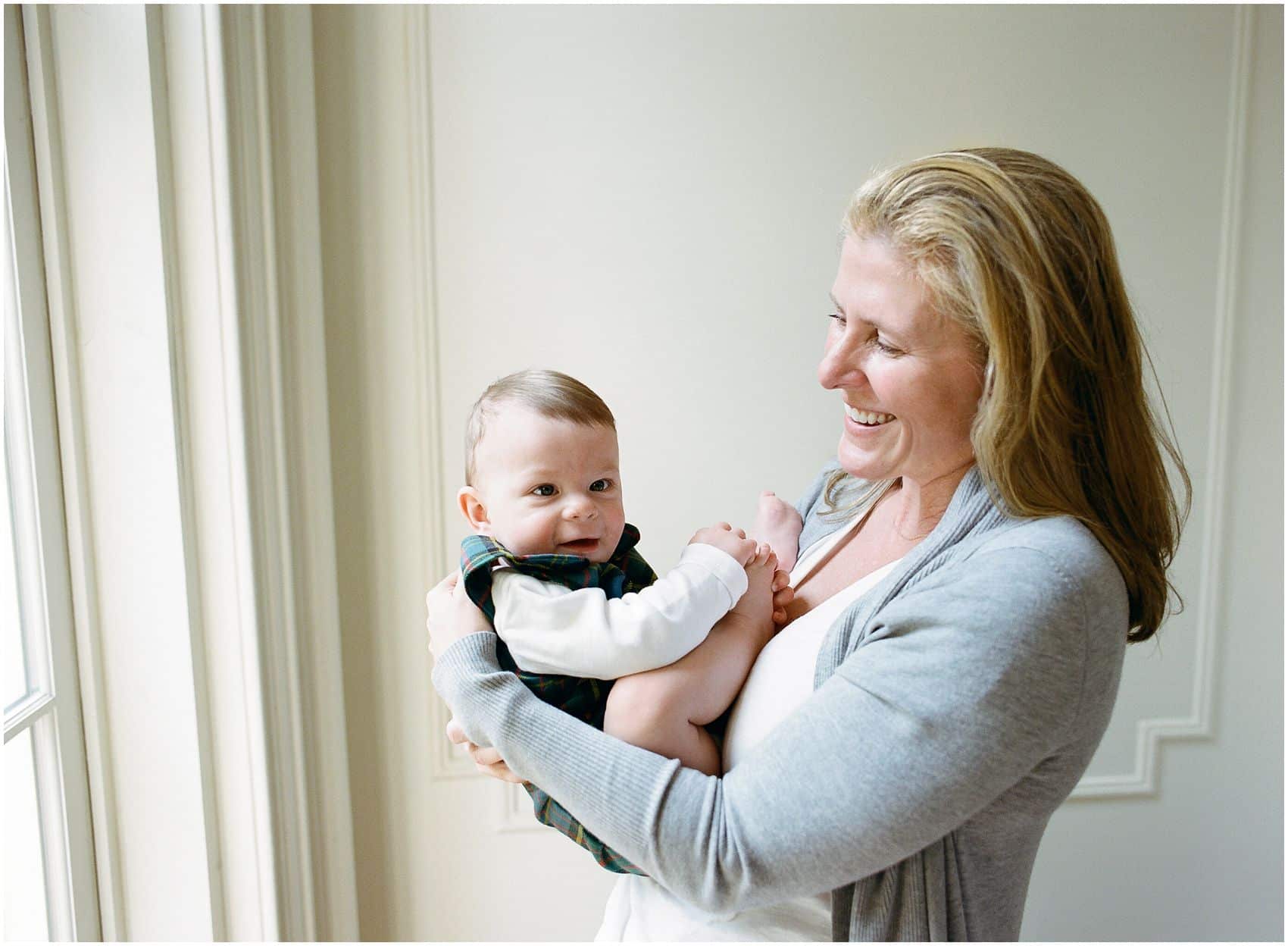 happy baby in mom's arms