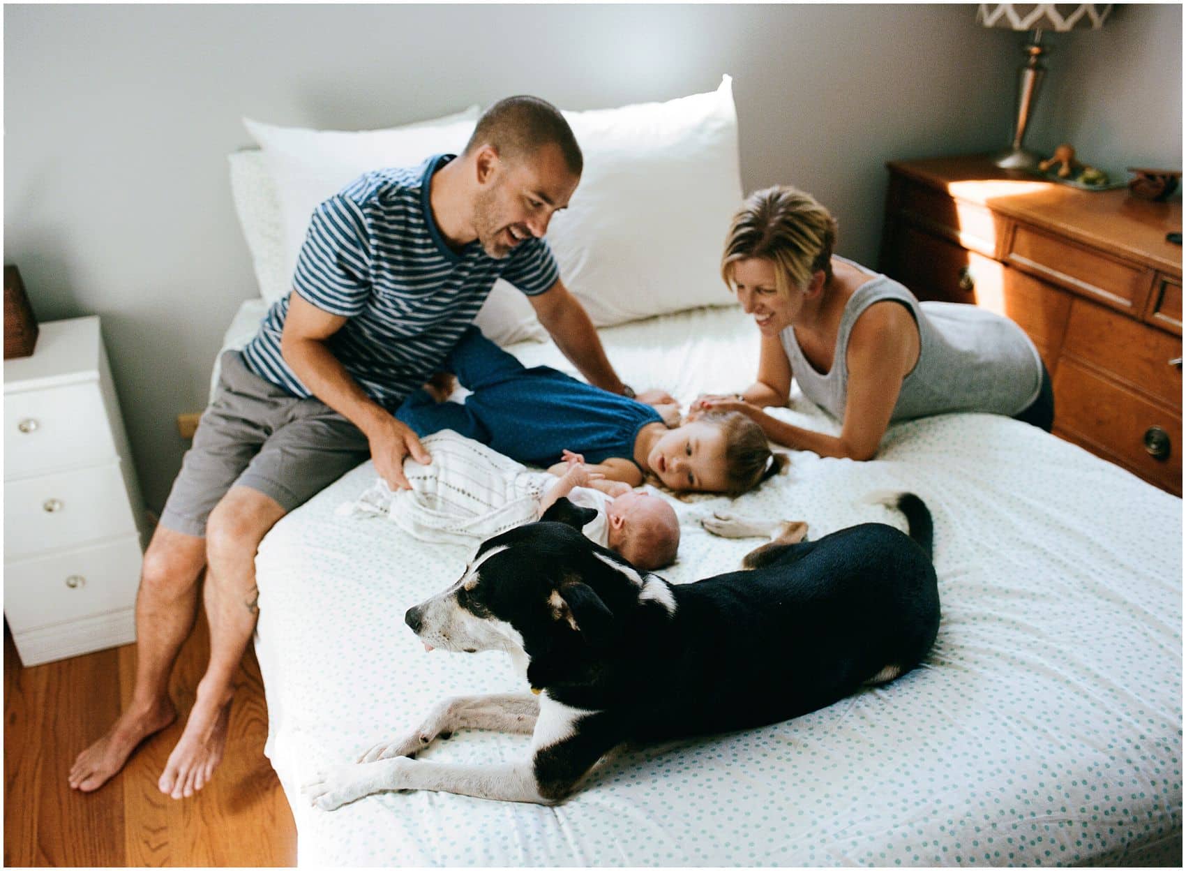 fun family photo in-home with new baby and a dog