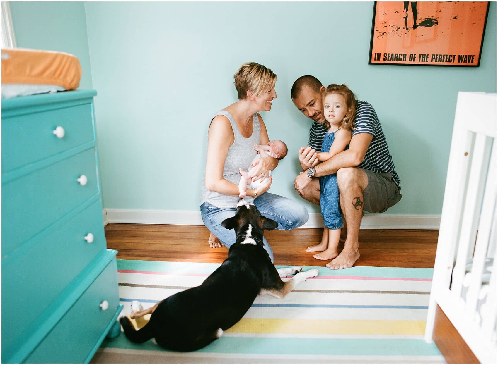 newborn photographer captures fun family portraits at home with a dog