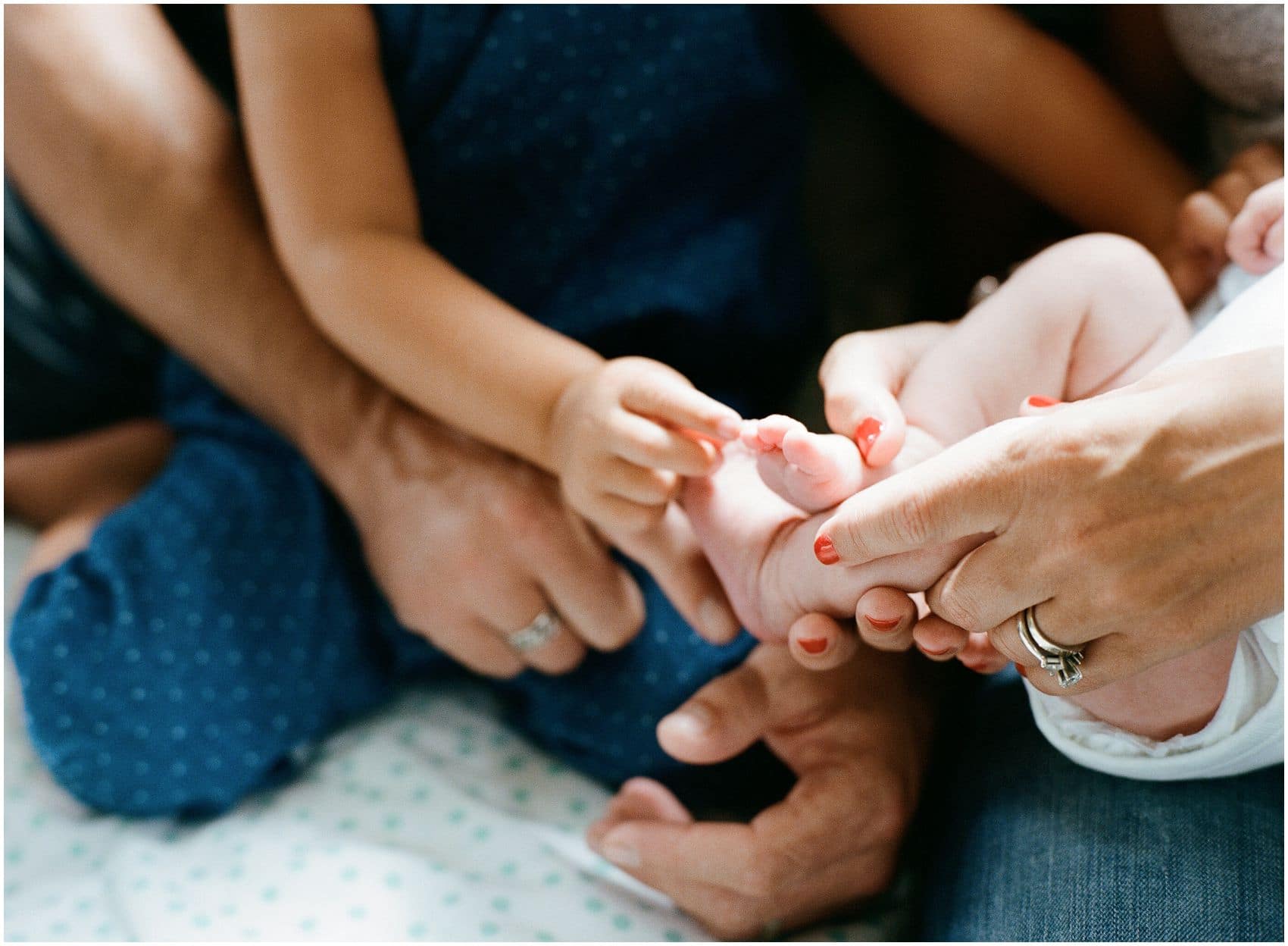 family loves to touch the new baby's toes