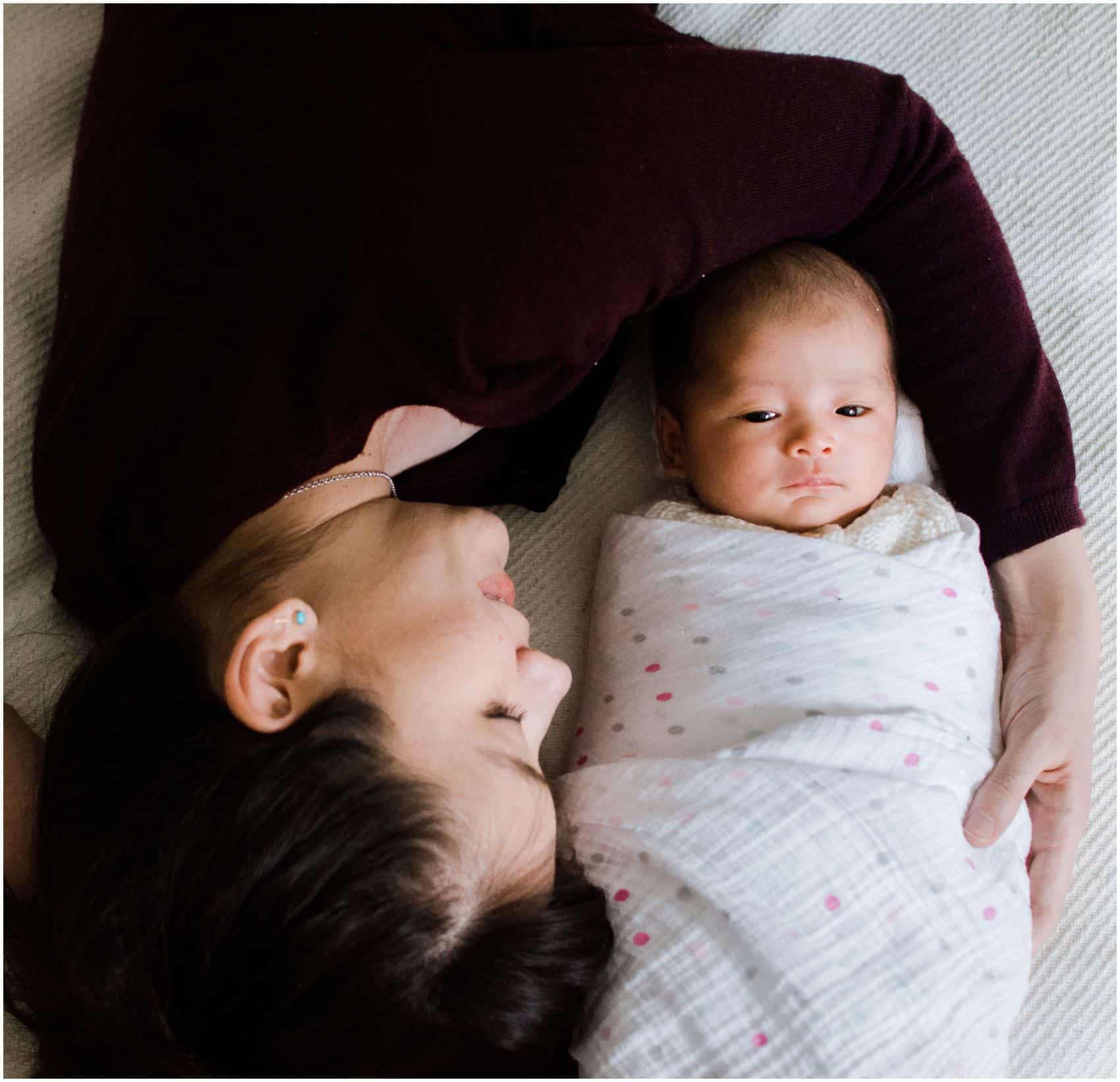 newborn photography NYC with mom cuddling around her baby