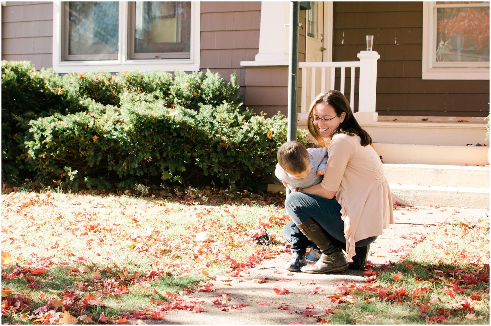 mom hugging her little boy in front of her home in Suffern NY