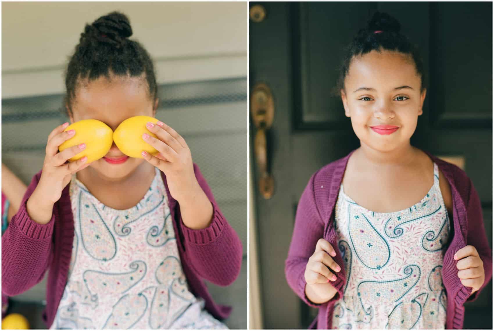 little girl posing for family photos and holding lemons in her Montclair NJ home