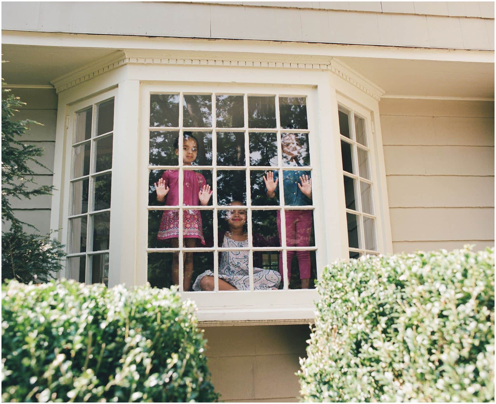 3 sisters looking out the window of their Verona NJ home