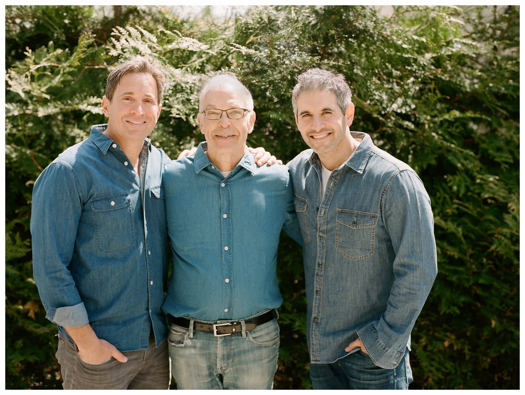 father and adult sons sharing a hug during extended family session at their home in Montclair NJ