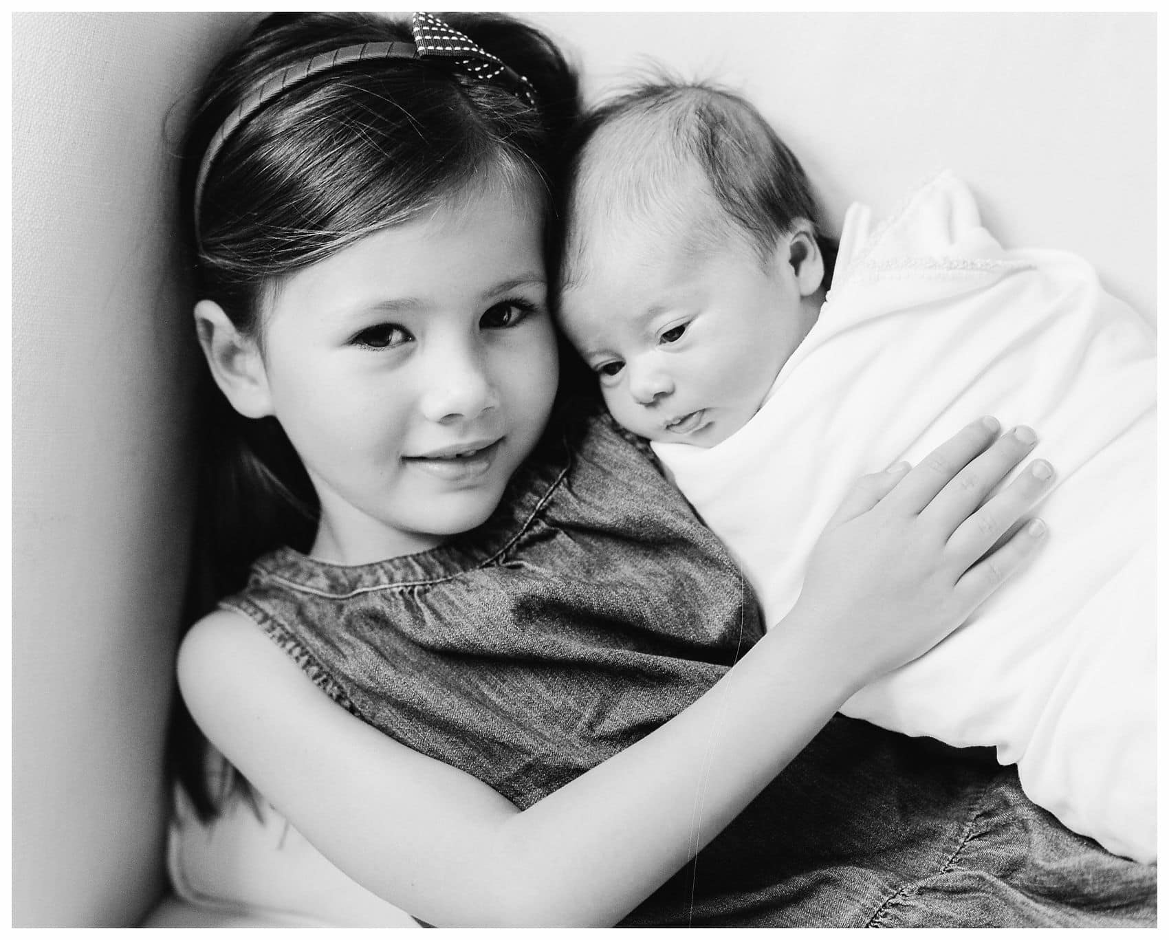 a portrait of a baby girl and her older sister is the best gift for the mother and grandmother in NYC