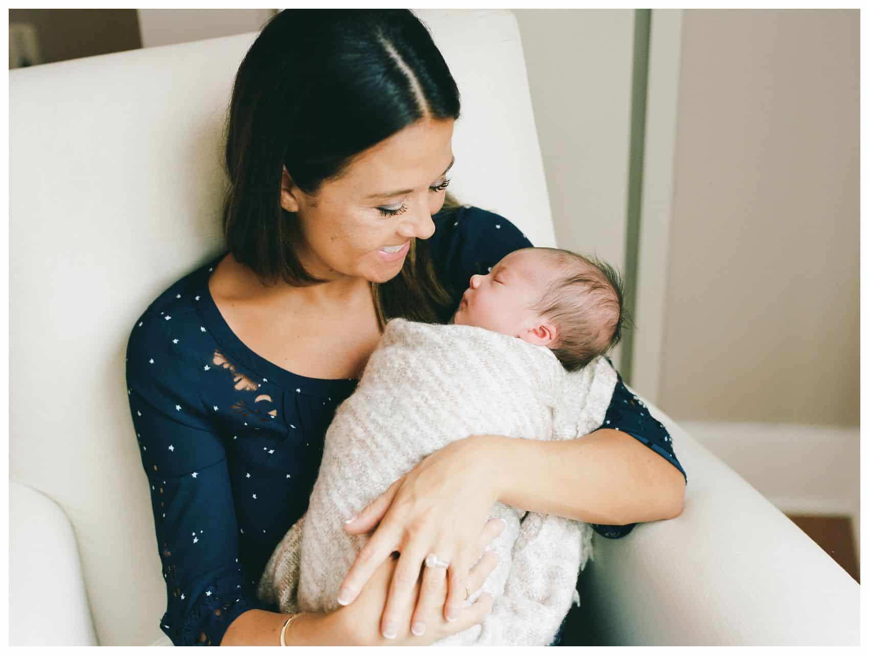 Smiling mom enjoying her newborn baby girl in newborn photography takin in NYC by Miriam Dubinsky Photography