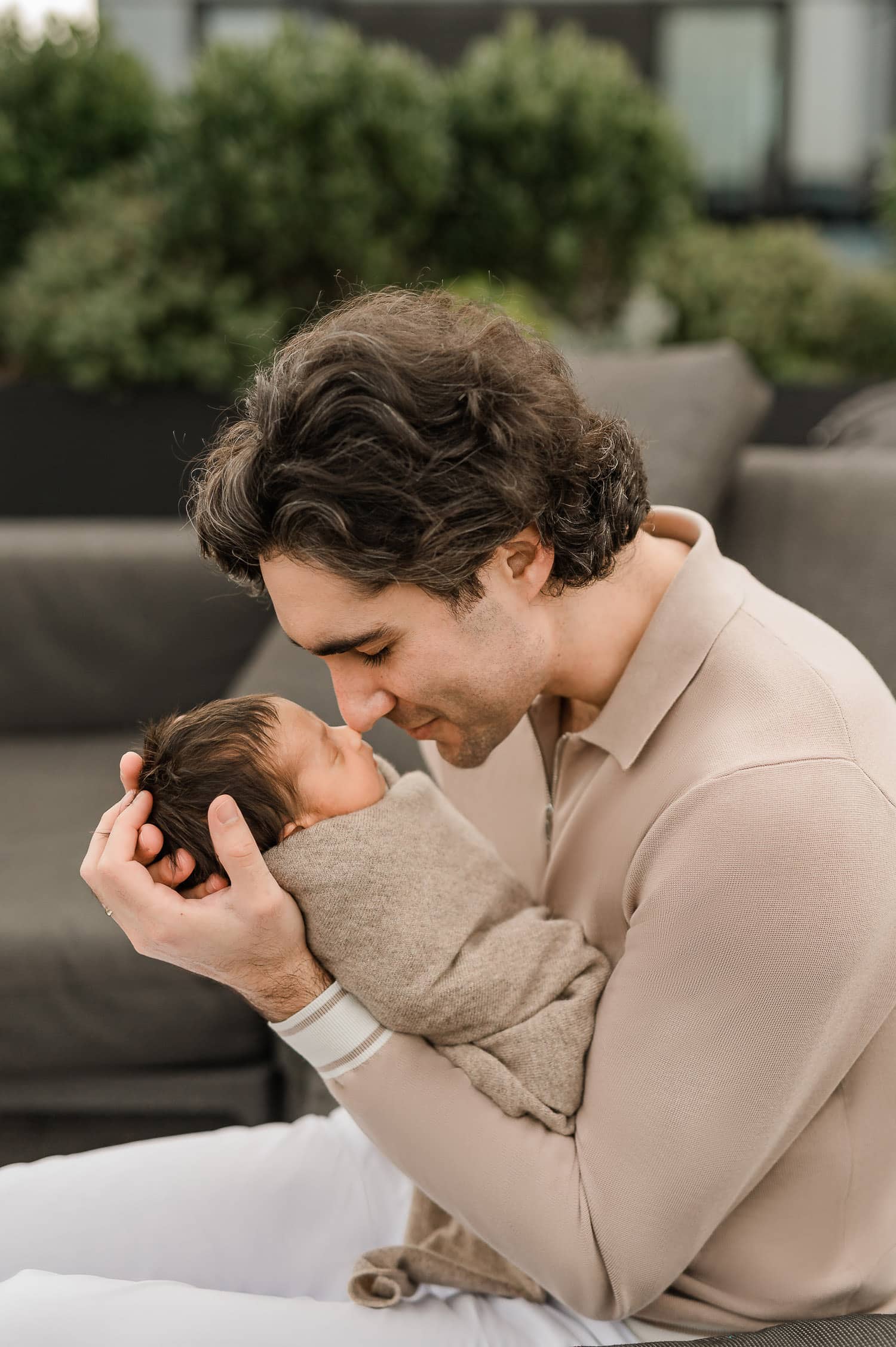 a tender moment with dad holding newborn baby closely at home in Manhattan